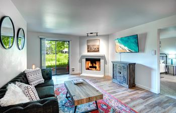 A modern living room with a fireplace and a flat screen tv